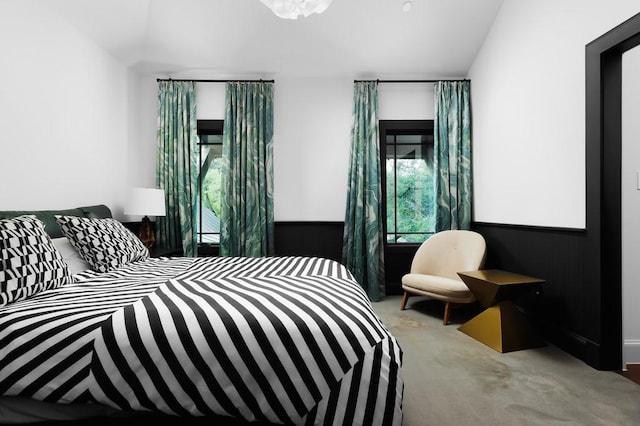 bedroom featuring light colored carpet and vaulted ceiling