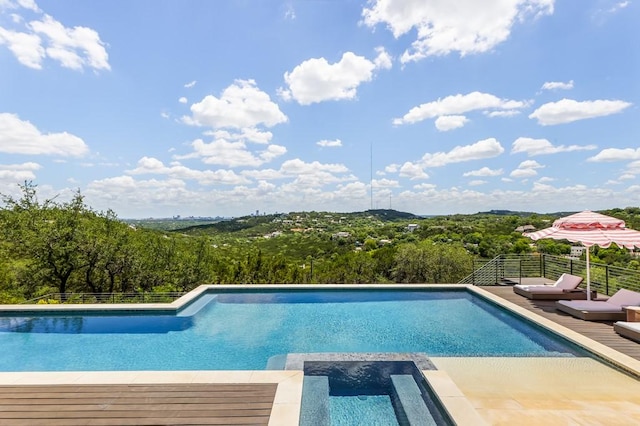 view of swimming pool featuring an in ground hot tub