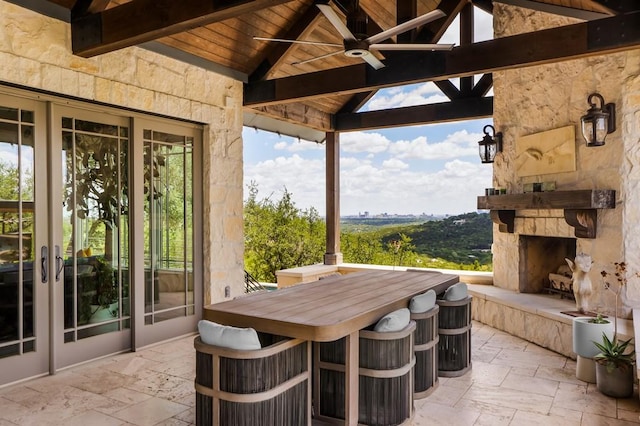 view of patio / terrace with a gazebo, an outdoor stone fireplace, and ceiling fan