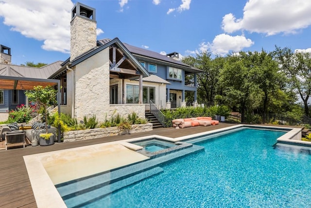 rear view of property with a swimming pool with hot tub