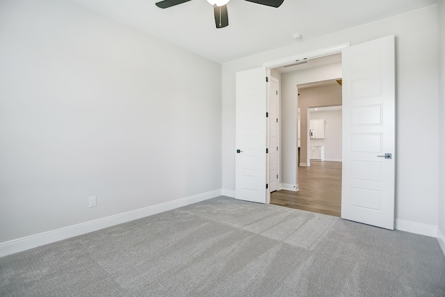 unfurnished bedroom featuring ceiling fan and carpet flooring