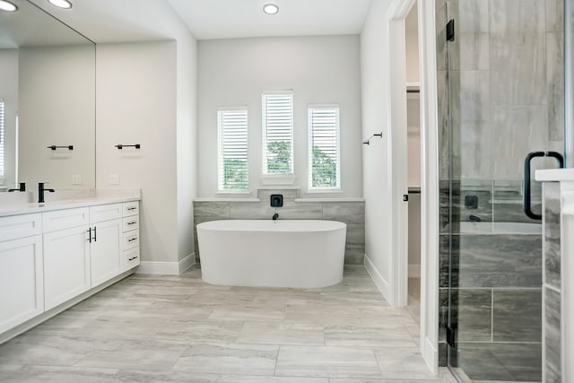 bathroom featuring vanity and separate shower and tub