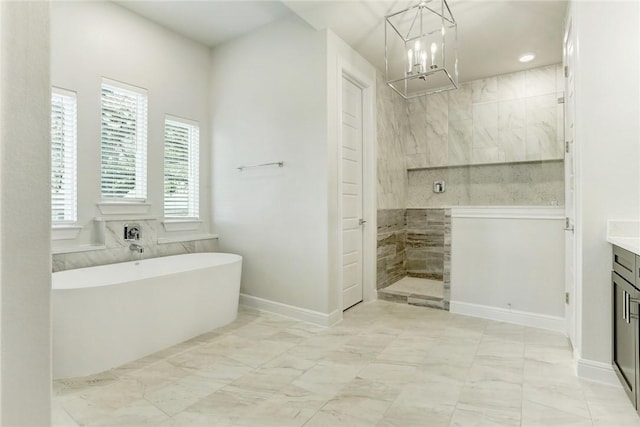 bathroom with vanity, a chandelier, and independent shower and bath