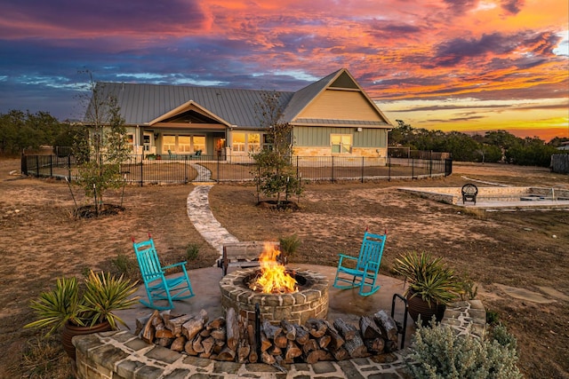 view of front of home with a fire pit and a patio area