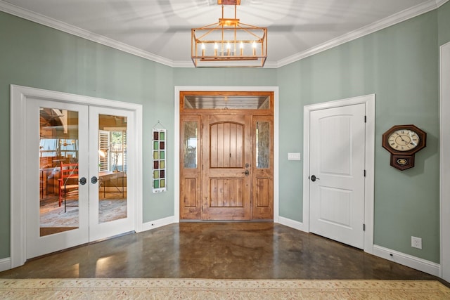 entrance foyer featuring a notable chandelier, french doors, and crown molding