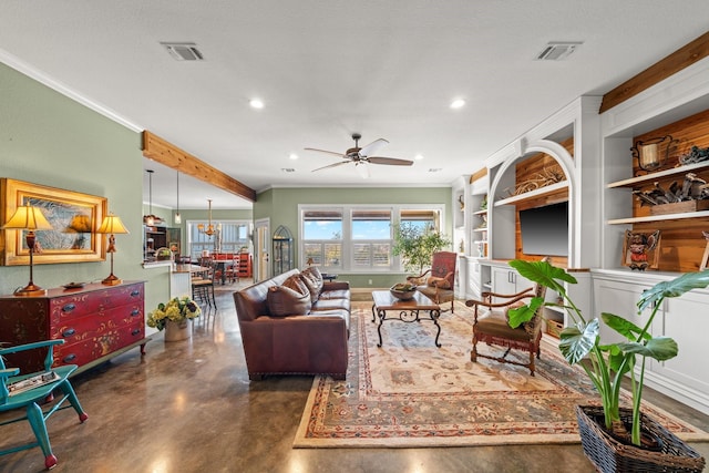 living room featuring ceiling fan with notable chandelier, a textured ceiling, ornamental molding, and built in shelves