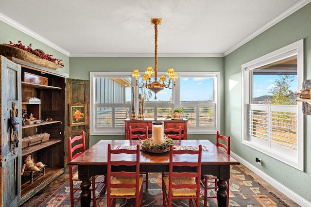 dining room featuring ornamental molding and a notable chandelier