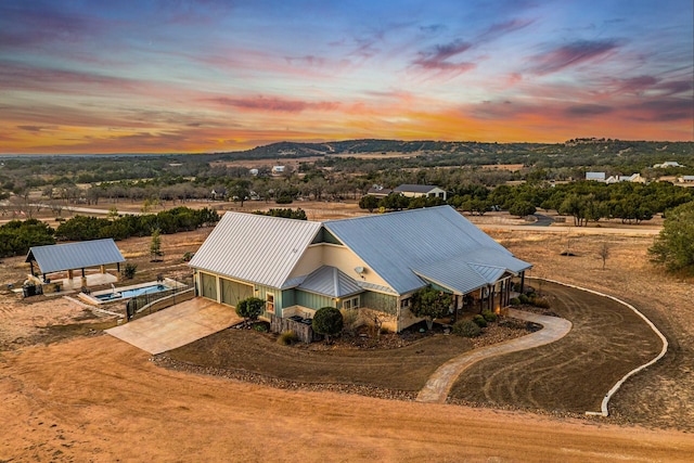 aerial view at dusk featuring a mountain view