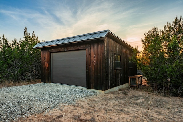 view of garage at dusk