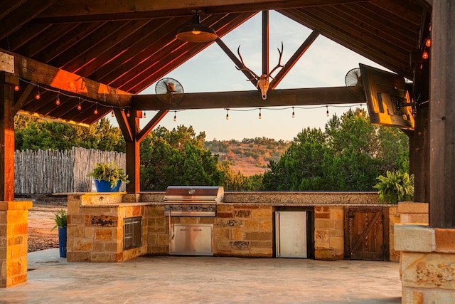 view of patio / terrace featuring area for grilling, exterior kitchen, and a gazebo