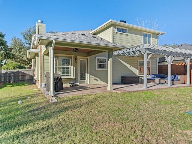 back of house featuring outdoor lounge area, a patio area, a lawn, and a pergola