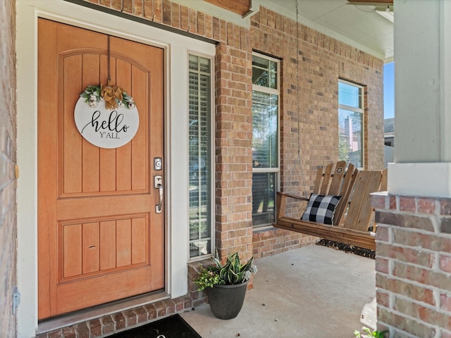 view of exterior entry featuring a porch