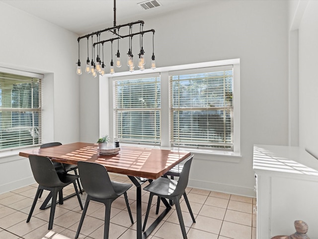 tiled dining space featuring a wealth of natural light