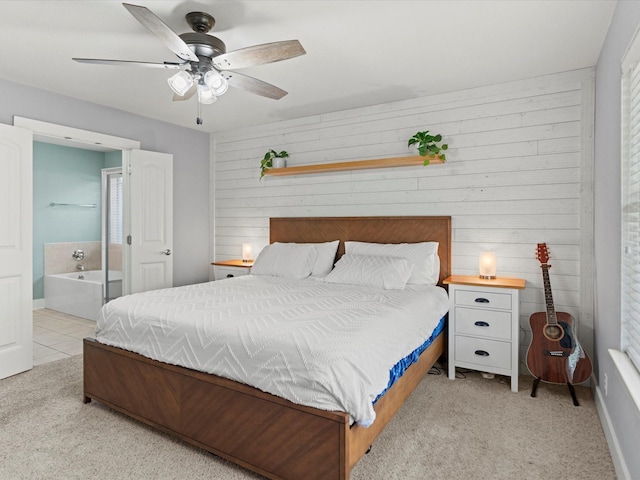 bedroom with wood walls, ceiling fan, and light colored carpet