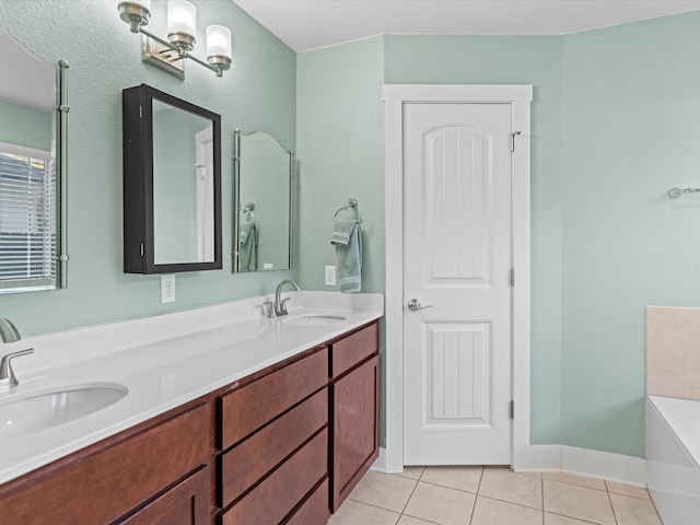 bathroom featuring tile patterned floors, a tub to relax in, and vanity