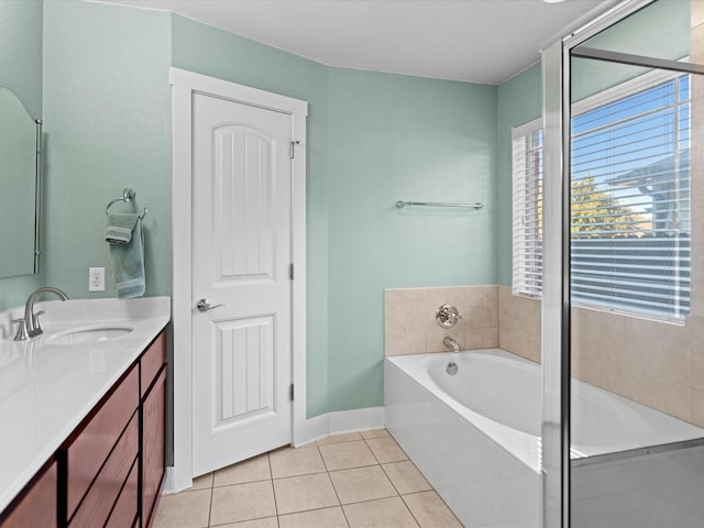 bathroom featuring vanity, tile patterned flooring, and a bath