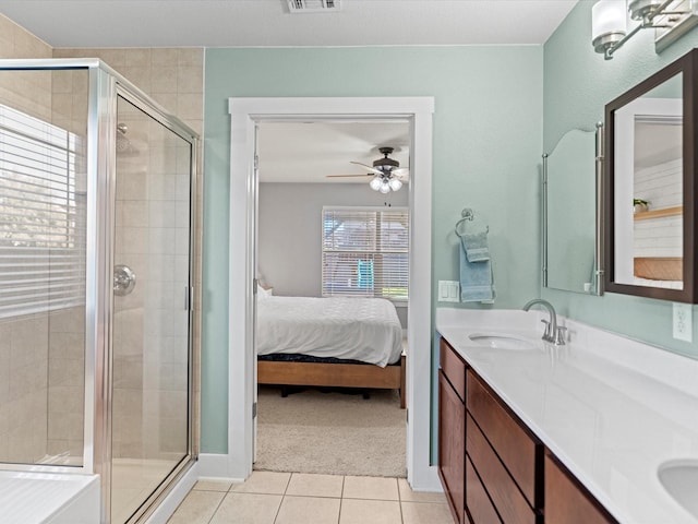 bathroom with a shower with door, ceiling fan, tile patterned floors, and vanity