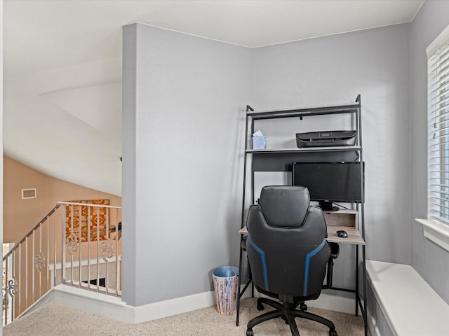 carpeted office with vaulted ceiling