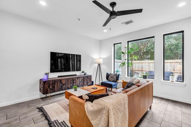 living room with a wealth of natural light and ceiling fan