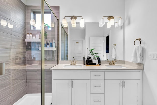 bathroom featuring vanity and a shower with door