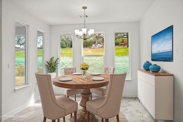 dining room featuring a notable chandelier, visible vents, marble finish floor, and baseboards