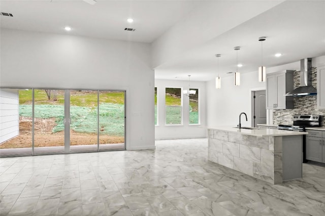 20714 Northland Dr, Lago Vista, TX 78645 - kitchen featuring wall chimney exhaust hood, electric range, light marble finish flooring, recessed lighting, and tasteful backsplash