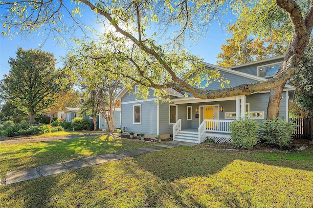 view of front of home featuring a front yard and covered porch