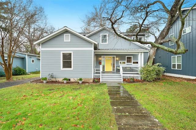 bungalow-style house with covered porch and a front yard