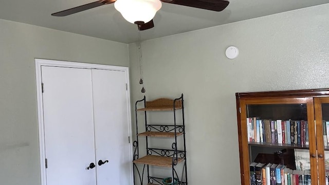 bedroom with ceiling fan and a closet