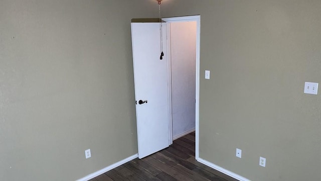 spare room featuring dark wood-type flooring