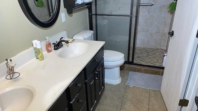 bathroom with a shower with door, tile patterned flooring, vanity, and toilet