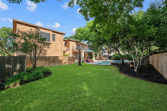 view of yard with a fenced in pool, a patio area, and a gazebo