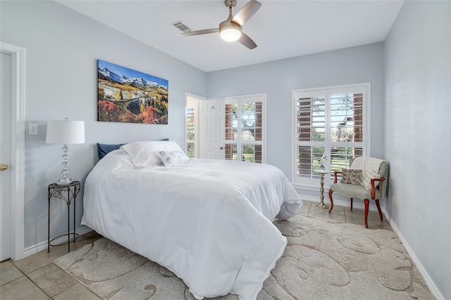 tiled bedroom with ceiling fan