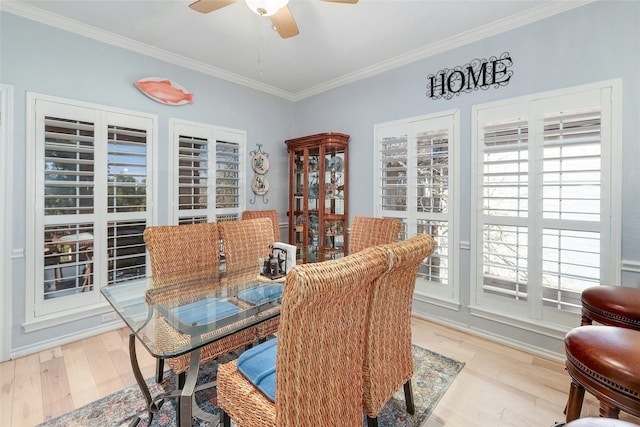 dining area with ornamental molding, plenty of natural light, and light hardwood / wood-style flooring