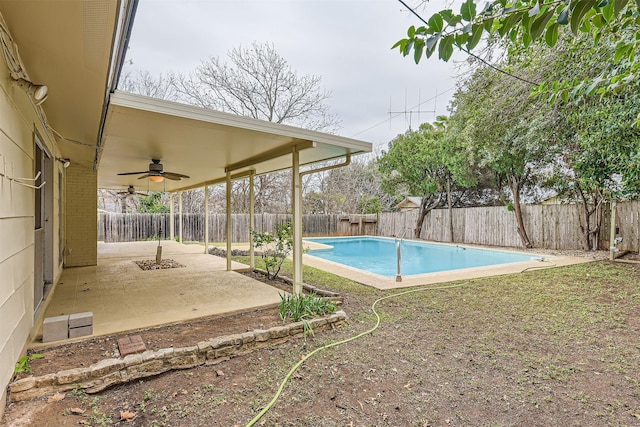 view of swimming pool featuring ceiling fan and a patio