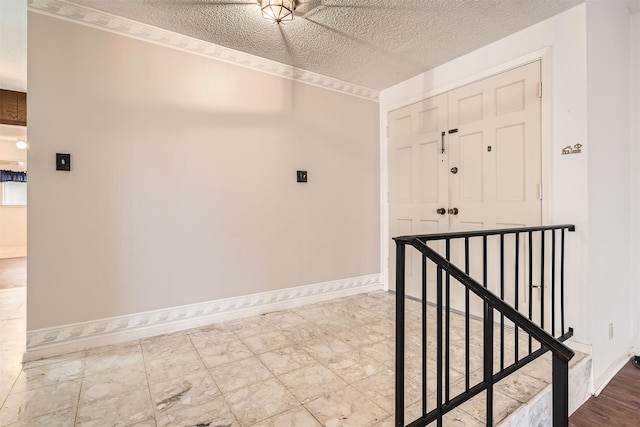 hallway with a textured ceiling