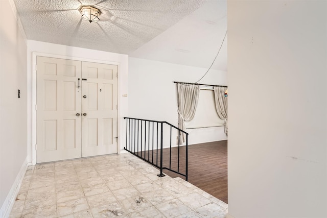 entrance foyer with a textured ceiling