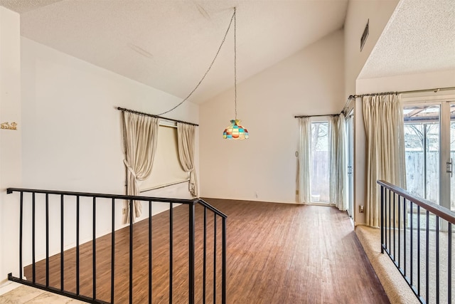 interior space featuring hardwood / wood-style floors and lofted ceiling