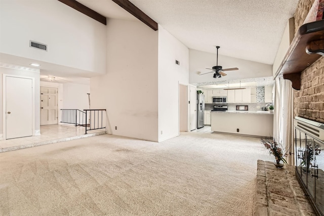 unfurnished living room featuring a textured ceiling, a fireplace, light carpet, ceiling fan, and high vaulted ceiling