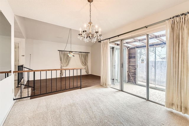 unfurnished room with a chandelier and carpet