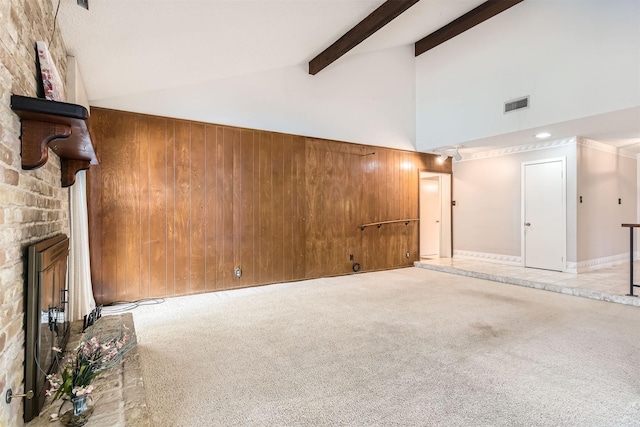 basement featuring a brick fireplace, wooden walls, and carpet flooring