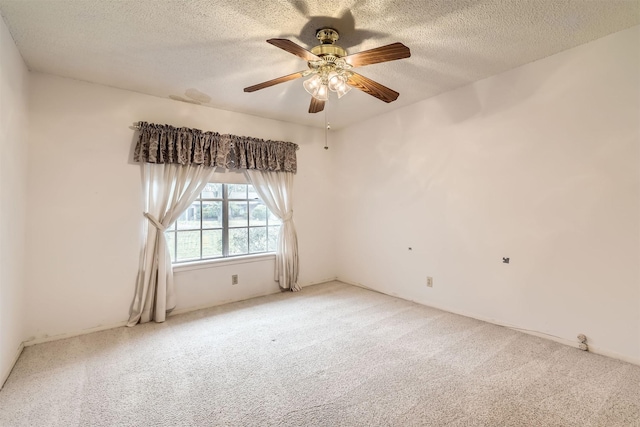 carpeted empty room with ceiling fan and a textured ceiling