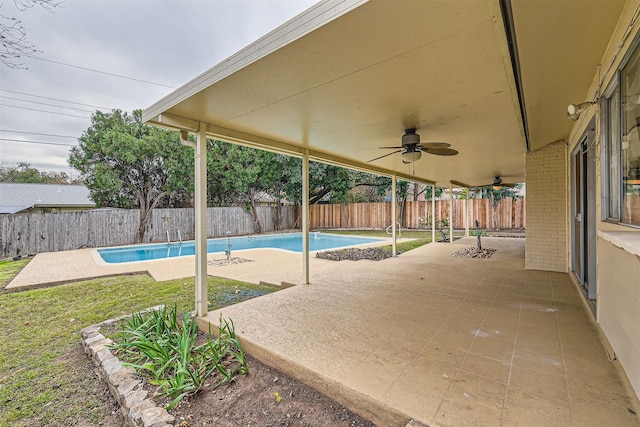 view of swimming pool featuring ceiling fan and a patio