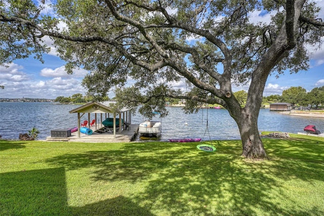 dock area featuring a lawn and a water view