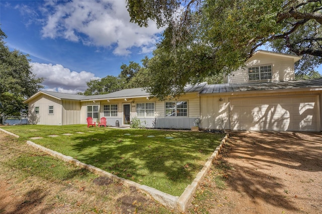 view of front of home featuring a garage and a front lawn