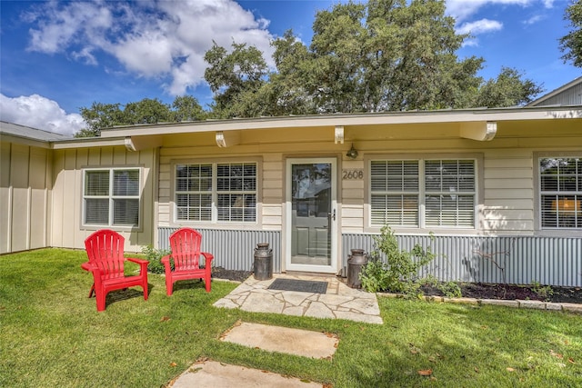 doorway to property featuring a yard