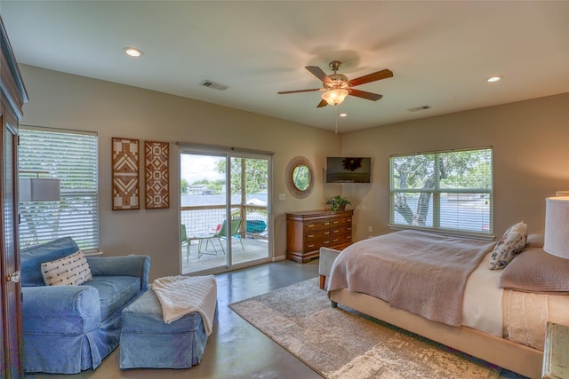 bedroom featuring ceiling fan, concrete flooring, and access to exterior