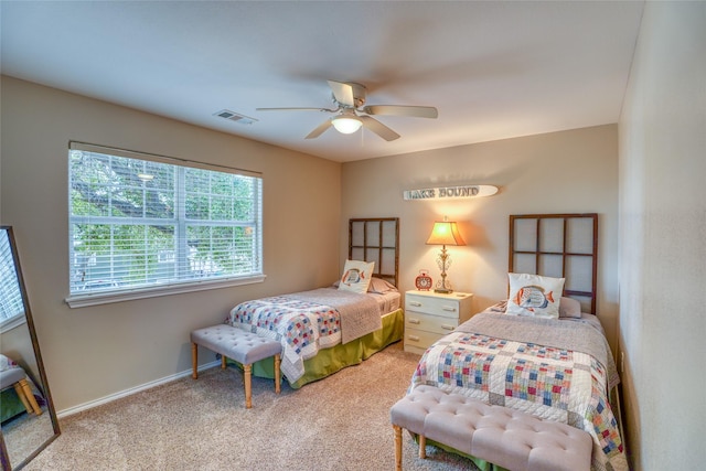 bedroom featuring ceiling fan and carpet