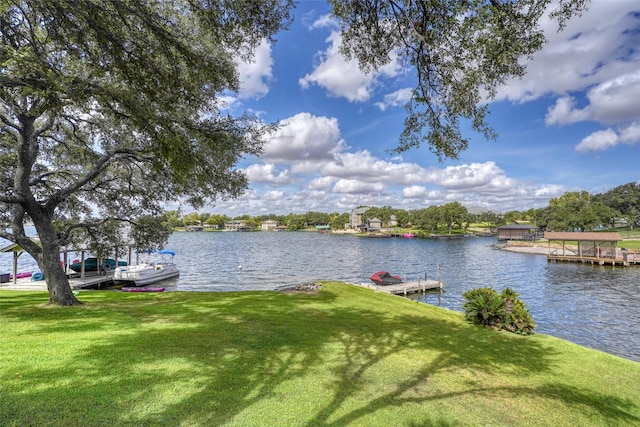 view of dock featuring a yard and a water view