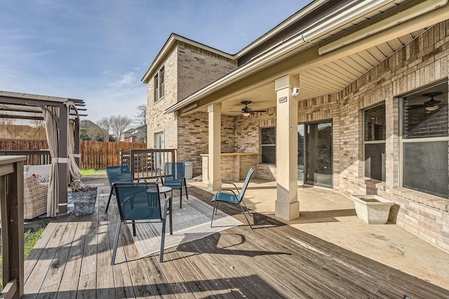 deck with ceiling fan and a fire pit